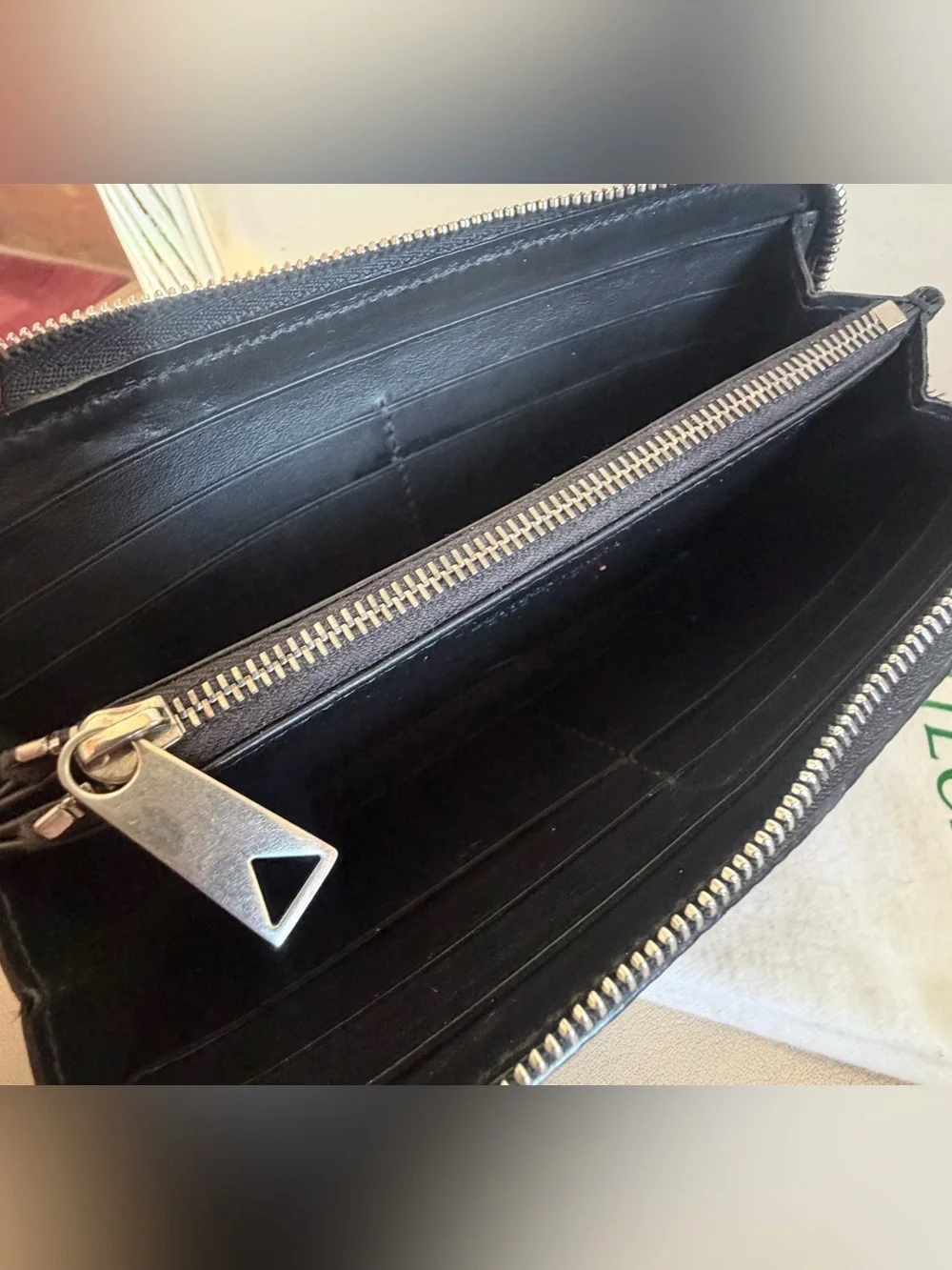BOTTEGA VENETA Black Zip Around Wallet in Intrecciato Debossed Calfskin. UNISEX.